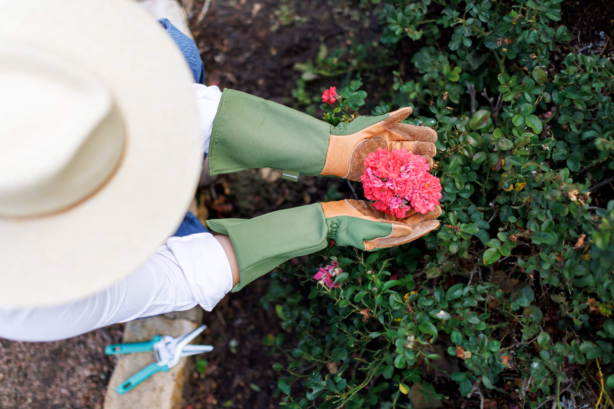 Woman wearing gloves for gardening roses from Wells Lamont
