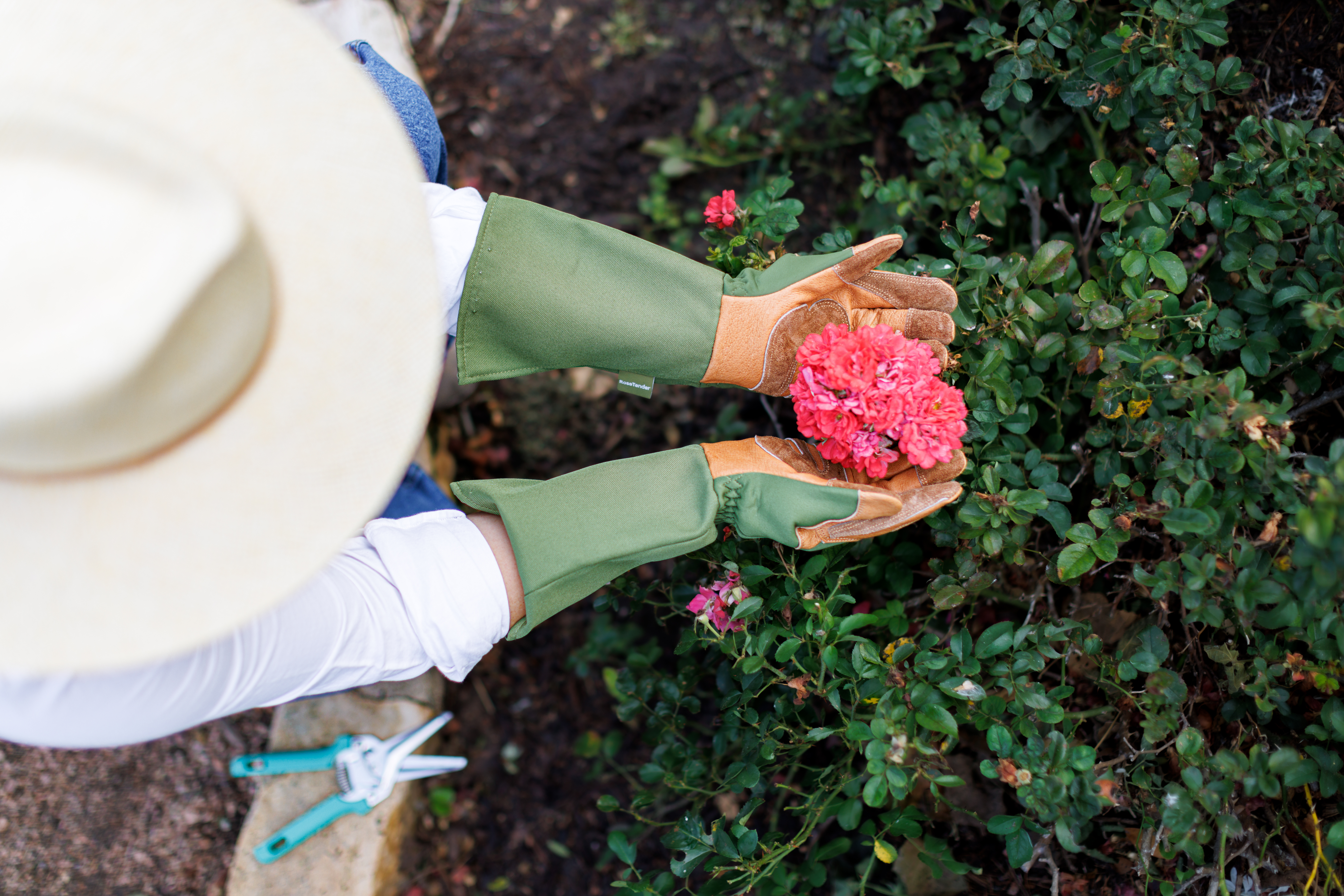 Woman wearing gloves for gardening roses from Wells Lamont